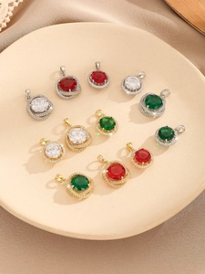 Detailed macro view of four-prong round zircon pendants in ruby, emerald, and clear stones