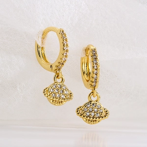 Minimalist gold plated planet pendant earrings with cubic zirconia on white mesh