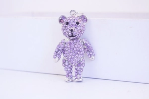 Close-up of purple crystal bear keychain with shiny rhinestones and silver metal finish