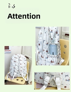 Detail view of white canvas backpack featuring cartoon dog prints and side water bottle pocket