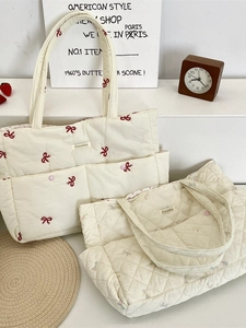 Quilted tote bags with embroidered floral bows and top handles for casual commuting