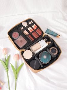 Macro view of partitioned interior of a portable PU makeup bag with brush slots