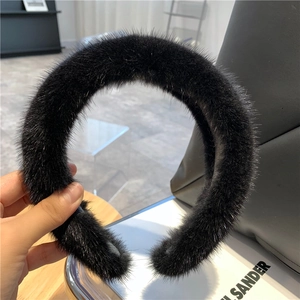 Close-up of a soft black faux mink fur headband with rich texture for women