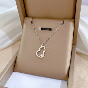 Minimalist silver titanium steel gourd necklace with a small diamond in a jewelry box