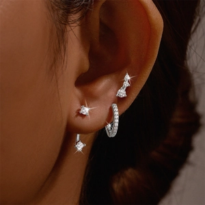 Detailed view of S925 sterling silver hoop earrings set with zirconia worn on model ear