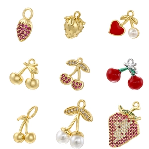 Detailed grid of nine golden fruit charms featuring strawberries and cherries with zircon