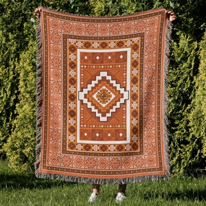 Detailed close-up showing Bohemian woven pattern and colorful tassels on outdoor camping blanket