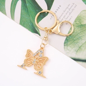 Close-up of gold butterfly keychain with crystal letter H and lobster clasp detail