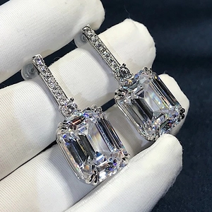 Elegant emerald cut drop earrings with sparkling pavé cubic zirconia in silver setting
