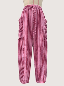 Detail of pink and red striped pants with elastic drawstring waist and side pockets