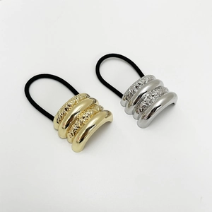 Detail of high-elasticity hair ties with textured gold and silver shell-shaped alloy buckles