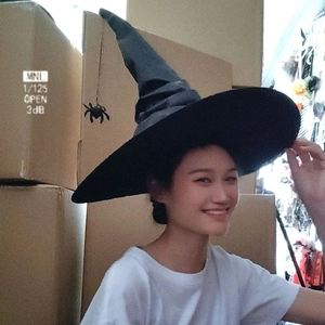 Classic black ruffled witch hat for Halloween party with pointed top and wide brim