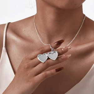 Polished heart locket necklace in silver finish with hinge opening feature for photos