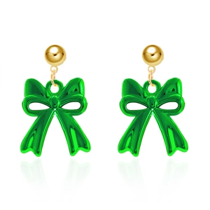 Detailed view of green resin bow earrings with gold studs and smooth reflective finish