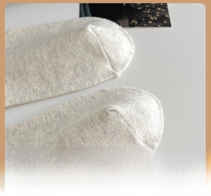 Detailed close-up showing reinforced toe stitching on white knit cotton crew socks