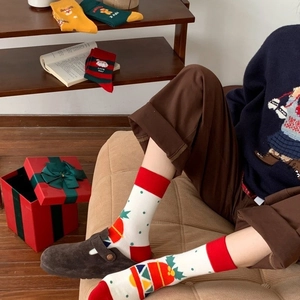 Festive Christmas mid-tube cotton socks with Santa and reindeer patterns in holiday colors