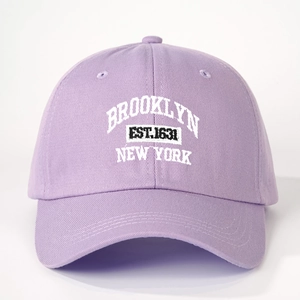 Close-up of white 3D embroidery on lavender Brooklyn New York cotton baseball cap