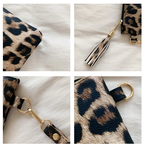 Macro details of leopard print clutch showing PU texture, tassel zipper and gold hardware