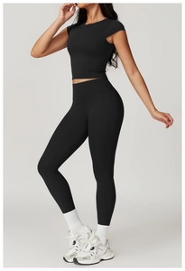 Close-up of black tight-fit yoga set featuring a cropped top and high-waist sports leggings