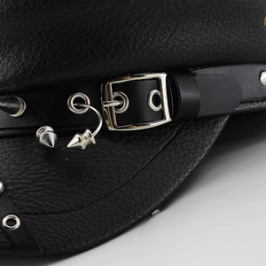 Close-up of black textured leather military cap featuring silver metal studs and punk spikes