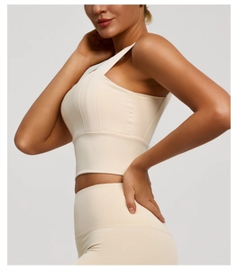 Close-up of seamless creamy white sports bra and high-waist yoga leggings set for fitness