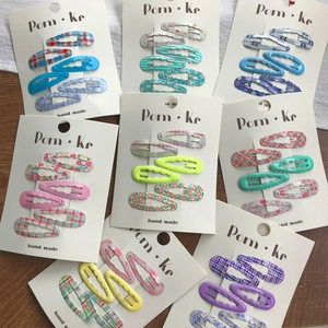 Set of cute wavy hair clips with floral and plaid patterns for women and girls
