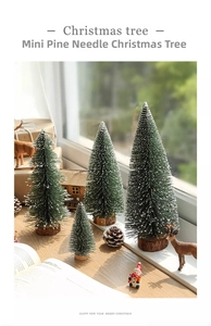 Miniature snow-flocked Christmas trees set with natural wood bases for festive decor