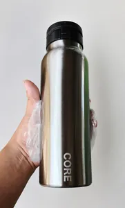 Macro detail of silver stainless steel water bottle with CORE logo and black lid