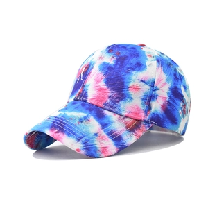 Detail view of cotton baseball cap with blue and pink star gradient tie-dye pattern
