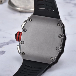 Detail of tonneau steel watch case back with matte finish and black rubber strap