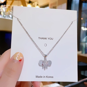 Elegant elephant pendant necklace with sparkling rhinestones and red gem accent details