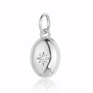 Detailed close-up of a silver oval pendant featuring a starburst motif and clear zircon stone