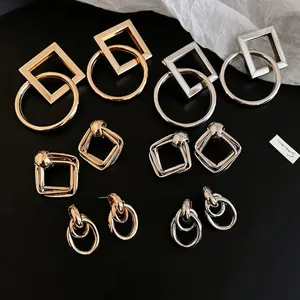 Set of minimalist geometric gold and silver stud earrings with high-shine metallic finish