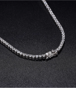 Macro shot of 2.5mm Moissanite tennis chain clasp and polished silver setting detail