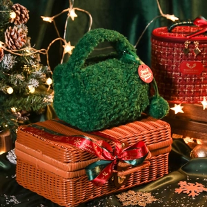 Festive forest green plush handbag on a brown wicker basket with Christmas decorations