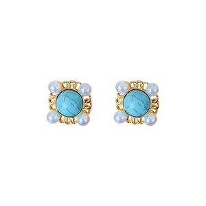 Vintage style gold earrings with blue turquoise center and four pearls on white background
