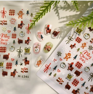 Detail of Christmas nail art stickers featuring gold dachshund and gingerbread man