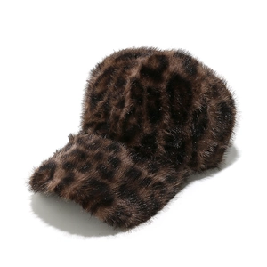Macro shot of fluffy leopard print faux fur texture on a warm winter baseball cap
