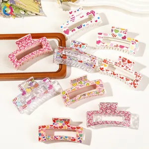 Close-up of heart pattern acrylic hair claws with diverse checkerboard and love prints