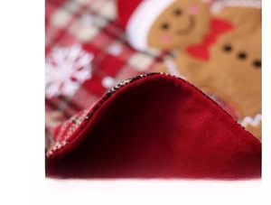 Detail of Christmas gingerbread man stocking with red plaid fabric and plush fleece lining