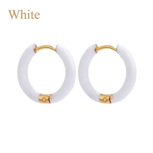 Detail of 12mm white enamel hoop earrings with a gold-plated stainless steel finish