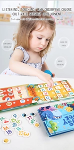 Detail of child using educational busy book for alphabet and number matching activities