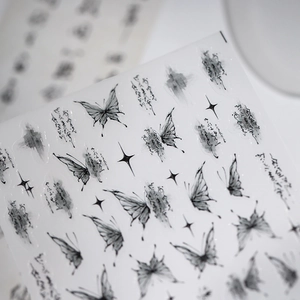 Ink style butterfly nail art stickers with stars and calligraphy in black aesthetic