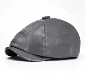 Close-up of grey PU leather texture and stitched seams on a vintage newsboy cap