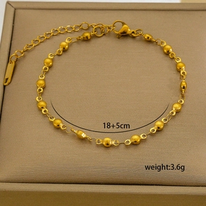 Detail of 18K gold-plated bead chain with lobster clasp and extension on jewelry box