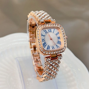 Detailed close-up of a rose gold square watch with crystal-encrusted bezel and Roman numerals