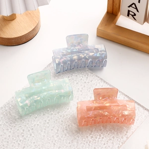 Three colorful square claw clips in blue, mint green and pink with acetate finish