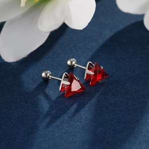 Macro detail of red triangle gemstone earrings with secure screw-back ball closures