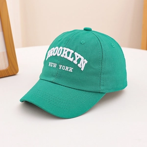 Close-up of white Brooklyn New York 3D embroidery on green cotton baseball cap