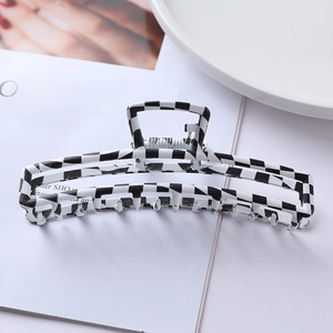 Detailed view of checkered black and white hair claw clip with strong spring structure